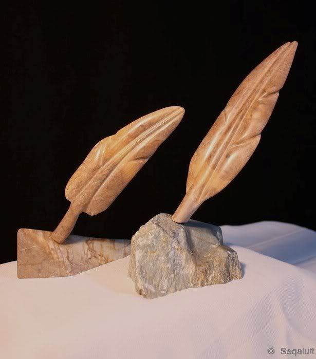 Two feather sculptures. The one on the left is for sale.